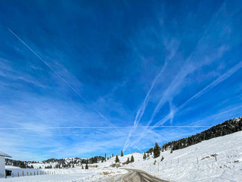 Scenic view of snowcapped mountains against blue sky
