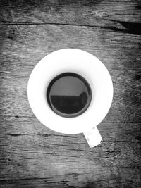 Directly above shot of coffee cup on wooden table