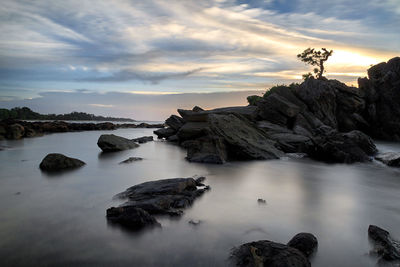 Rock formations in sea against sky