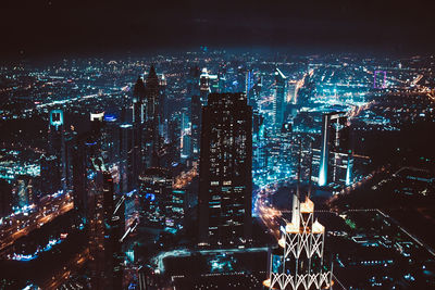 Aerial view of illuminated buildings in city at night