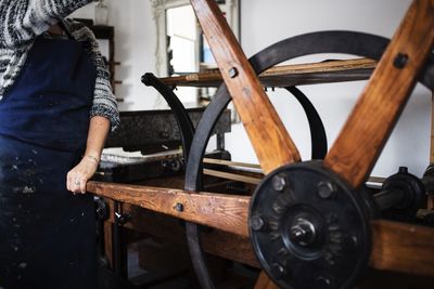 Midsection of woman working at workshop