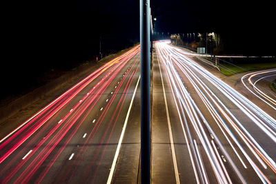 High angle view of light trails on highway at night
