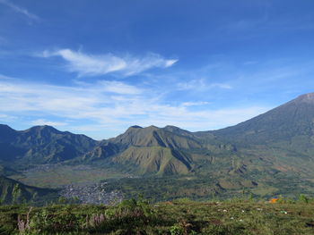 Scenic view of mountains against blue sky