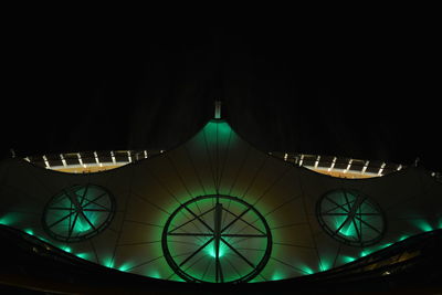 Low angle view of illuminated building against sky at night