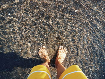 Low section of man in shallow water