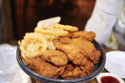 Close-up of fresh fried chicken served on table in restaurant