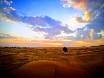 Scenic view of desert against sky during sunset