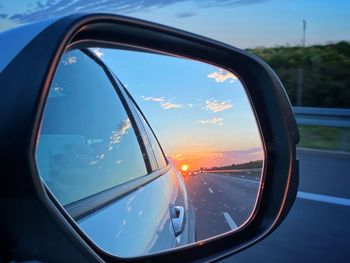 Reflection of sky on side-view mirror