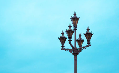 Low angle view of lamp post against clear blue sky