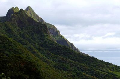 Scenic view of mountains against cloudy sky