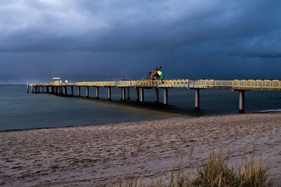 Pier over sea against sky