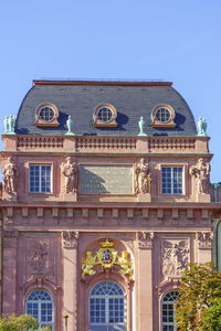 Low angle view of historical building against clear blue sky
