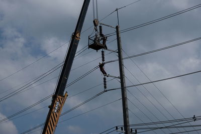 Low angle view of electricity pylon against sky