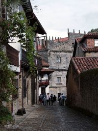 People walking on street amidst buildings in town