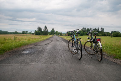 Bicycle on road against sky