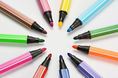 High angle view of colored pencils on white background