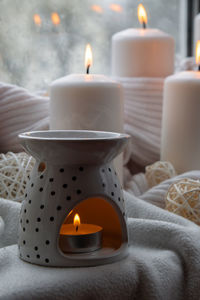 High angle view of illuminated candles on table