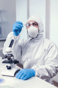 Female doctor examining chemical in laboratory