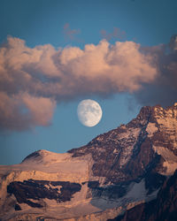 Scenic view of snowcapped mountains against sky during sunset