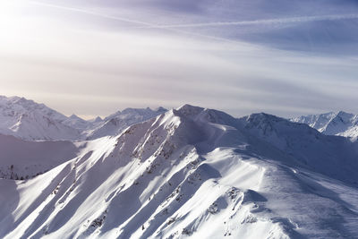 Scenic view of snowcapped mountains against sky