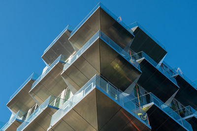 Low angle view of modern building against clear blue sky