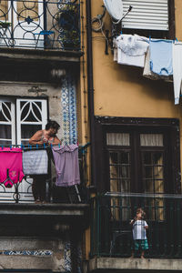 Rear view of woman on window of building