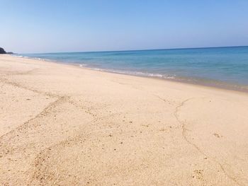 Scenic view of beach against clear sky