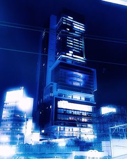 Low angle view of modern buildings at night