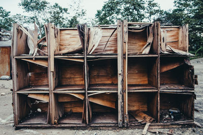 Abandoned wooden shelves on field
