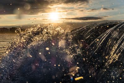 Close-up of sea against sky during sunset