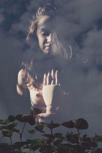 Double exposure of plants and woman against cloudy sky