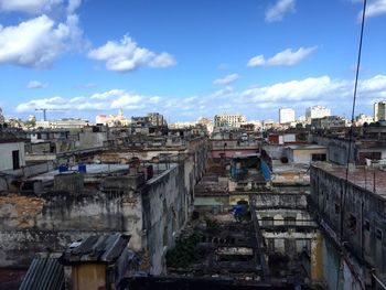 Buildings against cloudy sky