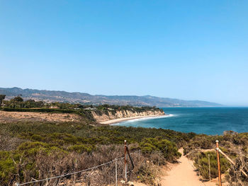 Scenic view of sea against clear blue sky