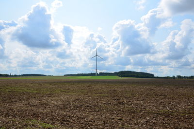 Windmill on field against sky