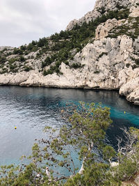 Scenic view of sea and mountains against sky