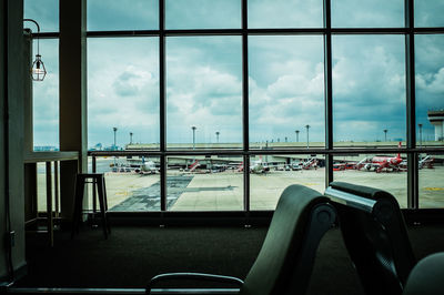 Empty seats in airport against sky