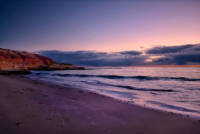 Scenic view of beach against sky during sunset