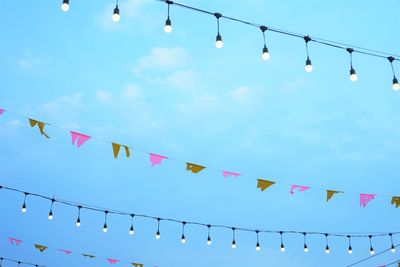 Low angle view of lanterns hanging against sky