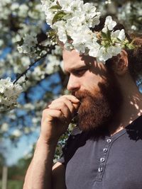 Low section of man wearing red flower plant