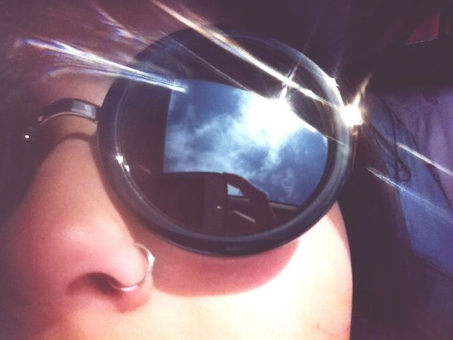reflection, part of, leisure activity, lifestyles, close-up, sunglasses, sky, person, sunlight, cropped, unrecognizable person, sun, lens flare, holding, circle, headshot, cloud - sky