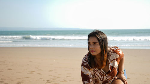 Portrait of beautiful young woman on beach