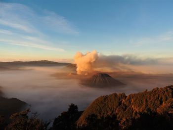 Panoramic view of volcanic mountain against sky during sunset