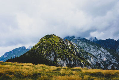 Scenic view of land and mountains against sky