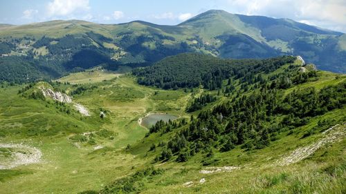 Scenic view of landscape and mountains against sky