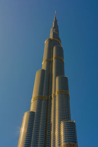 Low angle view of modern building against blue sky