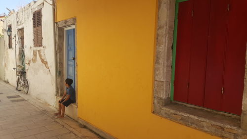 Midsection of woman on window