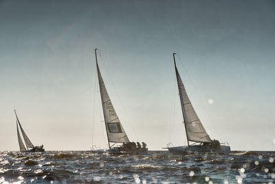 Boats in sea against sky