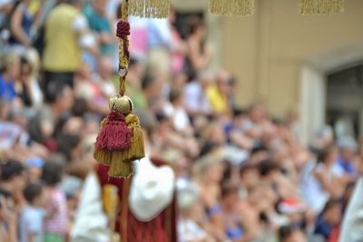 Close-up of tassel against people