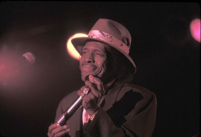 Portrait of man holding illuminated lighting equipment at night