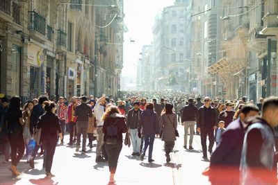 Group of people walking in front of buildings